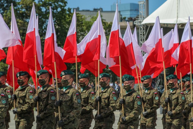 Polish Land Forces Soldiers march while carrying flags during an event commemorating the 100th anniversary of the Battle of Warsaw and Armed Forces Day in Warsaw, Poland, Aug. 15, 2020. The ceremonies recognized the skill, determination, and hard-fought victory of the Polish defenders in its decisive battle a century ago. (U.S. Army photo by Cpl. Justin W. Stafford)
