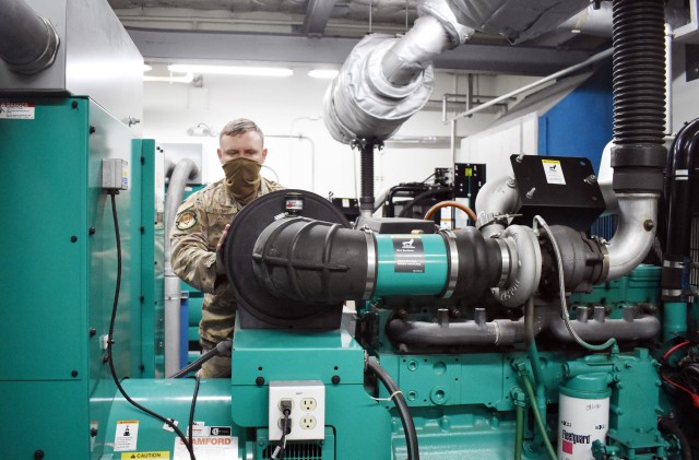 Air Force Staff Sgt. Spencer Erhart, a civil engineer assigned to 374th Communications Squadron’s Operating Location C, works on a generator in Building 771 at Camp Zama, Japan, July 24.