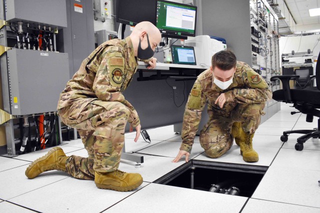Air Force Staff Sgt. Christopher Watson, right, and Senior Airman Brandon Boiles, assigned to 374th Communications Squadron’s Operating Location C, work in Building 771 at Camp Zama, Japan, July 24.