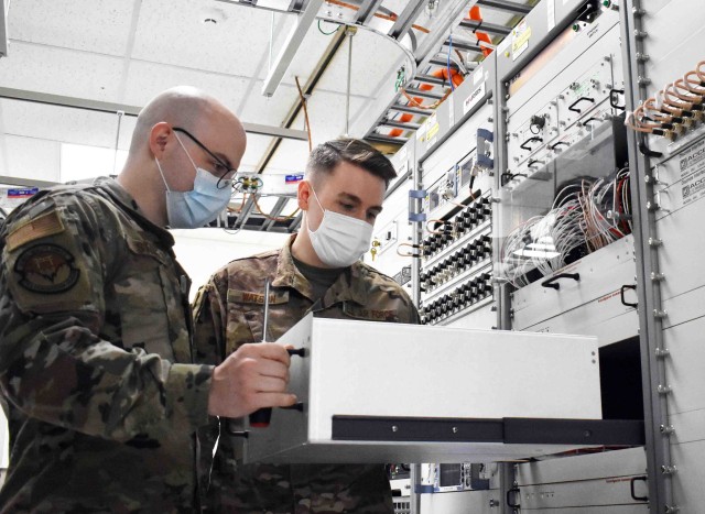 Airman Haven Stone, left, and Air Force Staff Sgt. Christopher Watson, assigned to 374th Communications Squadron’s Operating Location C, work in Building 771 at Camp Zama, Japan, July 24.