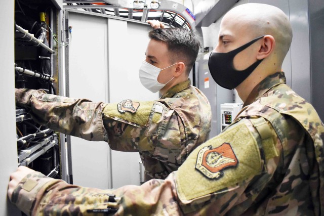 Air Force Staff Sgt. Christopher Watson, left, and Senior Airman Brandon Boiles, assigned to 374th Communications Squadron’s Operating Location C, work in Building 771 at Camp Zama, Japan, July 24.