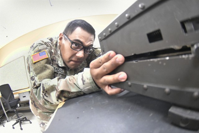 Pfc. Eliud Salas, 31, Bravo Company, 832nd Ordnance Battalion, examines a part on the M3P .50 caliber heavy machine gun as directed by his instructor during the 94T Short Range Air Defense System Repairer Course training Aug. 12 at Boyd Hall.