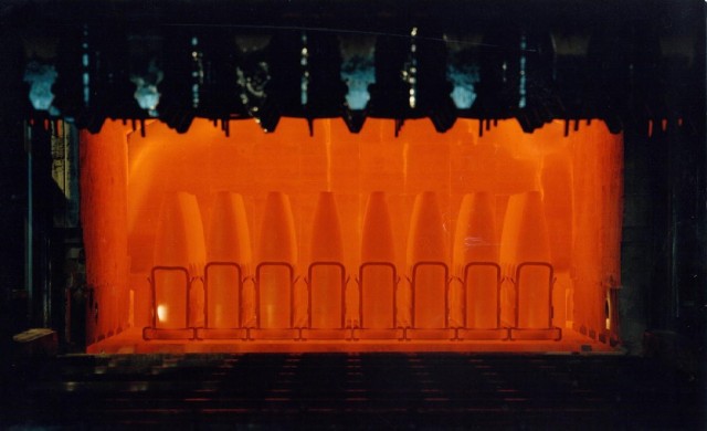 Projectile tubes exit a hardening furnace to complete the heat treat process, one of the last steps in the transformation process from a metal tube to a projectile case at Scranton Army Ammunition Plant.