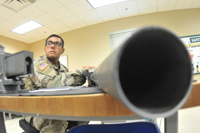 Pfc. Eliud Salas, 31, Bravo Company, 832nd Ordnance Battalion, listens to his instructor as an  M3P.50 caliber heavy machine gun stands ready for disassembly during the 94T Short Range Air Defense System Repairer Course training Aug. 12 at Boyd Hall.