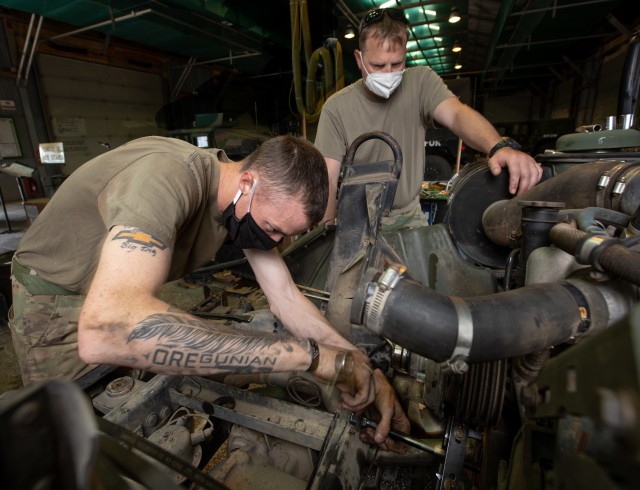 Sgt. Jason Bergstad and Spc. Andrew Gross of the 41st Infantry Brigade Combat Team, Oregon National Guard, work on replacing the Front Main Seal of M998 HMMWV on Camp Bondsteel, Kosovo Aug. 12. (U.S. Army National Guard photo by Maj. W. Chris Clyne)