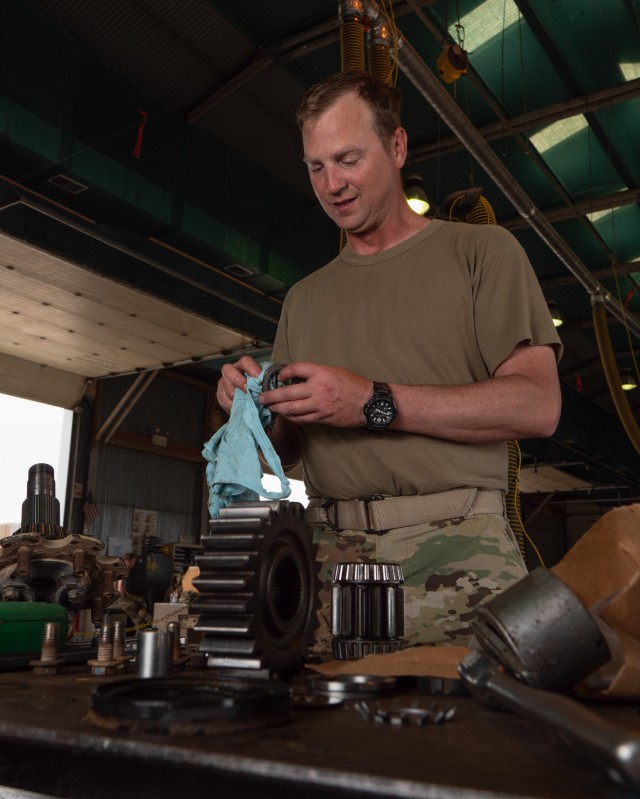 Sgt. Jason Bergstad,  41st Infantry Brigade Combat Team, Oregon National Guarda, a trained Heating, ventilation, and air conditioning (HVAC) mechanic volunteered to work on RC-E vehicles during the COVID outbreak, rebuilding a Rear Gear Hub of an M998 HMMWV on Camp Bondsteel, Kosovo July 27. (U.S. Army National Guard photo by Maj. W. Chris Clyne)