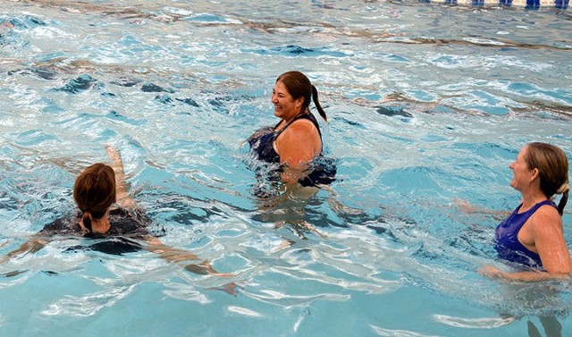 Water aerobics instructor Julie Keller leads participants during the class Aug. 14 at Harney Sports Complex. The class, the first to be offered at the post gyms since COVID-19 precautions shut down most activities, is limited to a maximum of 13 participants on a first-come, first-served basis. The class is offered at 4:30 p.m. Monday, Wednesday and Friday. Photo by Prudence Siebert/Fort Leavenworth Lamp