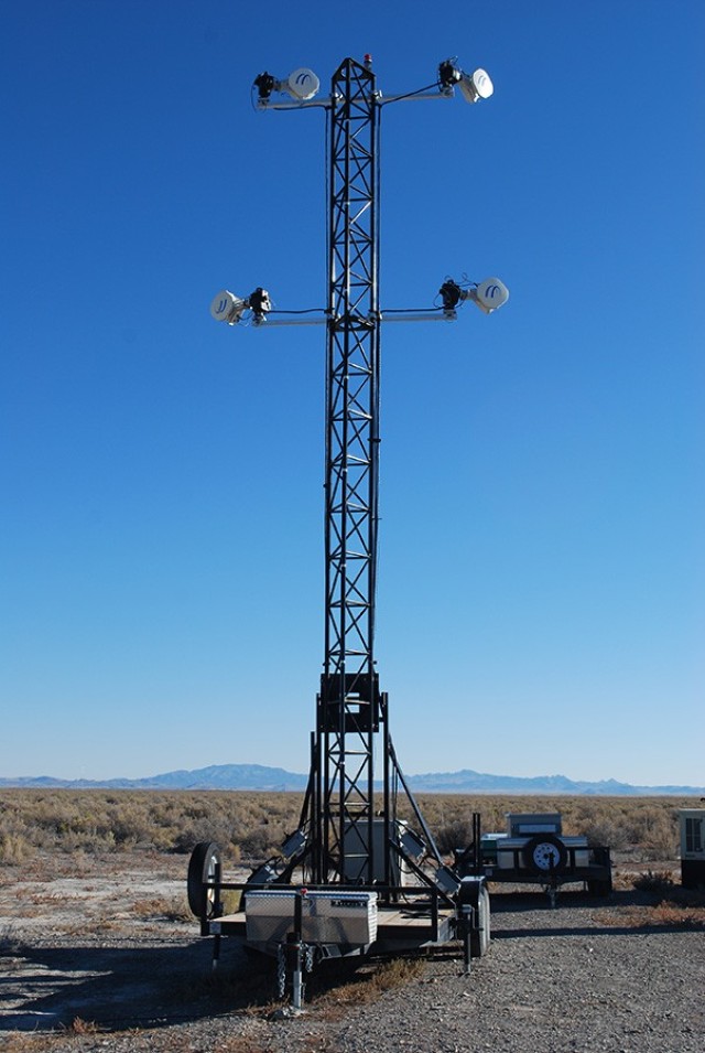 A trailer-mounted instrument tower used for outdoor testing of defenses against simulated chemical and biological agents at Dugway Proving Ground. The 10-meter tower folds down for ease in attaching instruments. The upgrade of hardware and software through OADMS depends upon this kind of mobility for test setup and, in the future, “safari” capability to take the testing system off DPG to other installations.  Photo by Joe Mashinski 
Dugway 