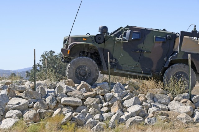 During the week of August 9, 2020, Fort Hunter Liggett hosted its first-ever Joint Light Tactical Vehicle (JLTV) class. This hands-on course teaches Soldiers how to maintain and operate the vehicle through classroom and field training. This vehicle is driving over the Rock Garden obstacle. (Photo by Amy Phillips)