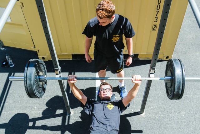 Class of 2022 Cadet Andrew Watts works out while Class of 2022 Cadet Ty Homan spots him on outdoor gym equipment set up for the cadets to limit overcrowding at the indoor gyms.