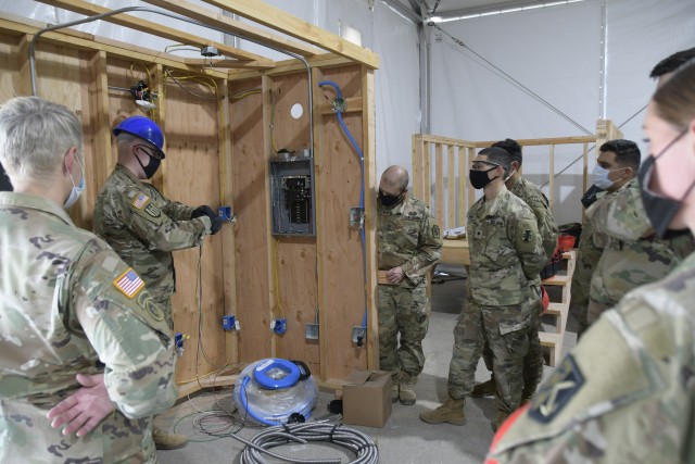 Instructor Sgt. 1st Class Christopher Knecht with the 12th Battalion, 104th Engineer Regiment, 1st Brigade, 102nd Engineer Training Division showing basic wiring concepts to students of the inaugural 12R Interior Electrician military occupational...