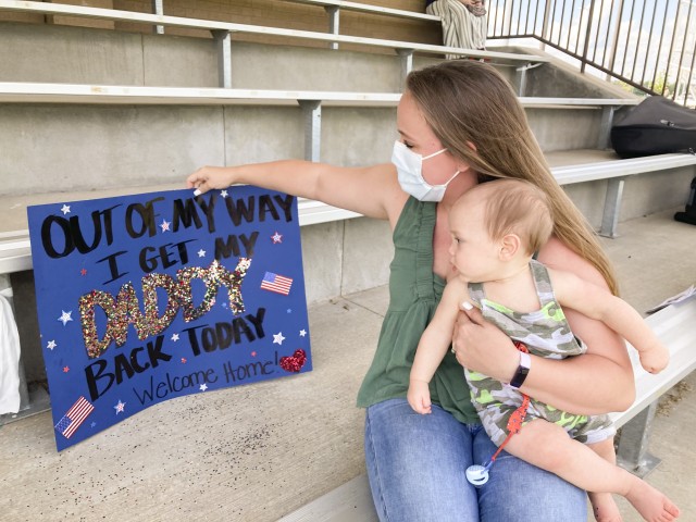Lakota Moody and her 9-month-old son, Walker, wait for Cpl. Taylor Moody, 1st Battalion, 187 Infantry Regiment, 1st Brigade Combat Team, 101st Airborne Division (Air Assault), Aug. 18 during a welcome home ceremony at division parade field....