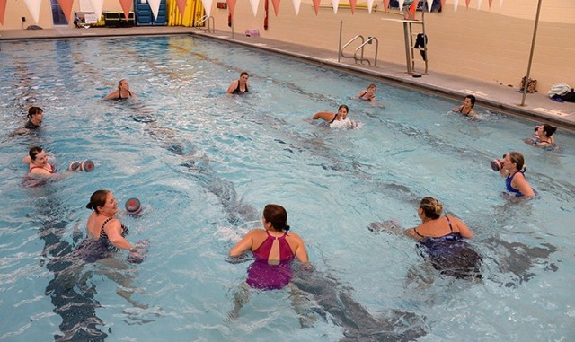 Water aerobics instructor Julie Keller leads participants during the class Aug. 14 at Harney Sports Complex. The class, the first to be offered at the post gyms since COVID-19 precautions shut down most activities, is limited to a maximum of 13...