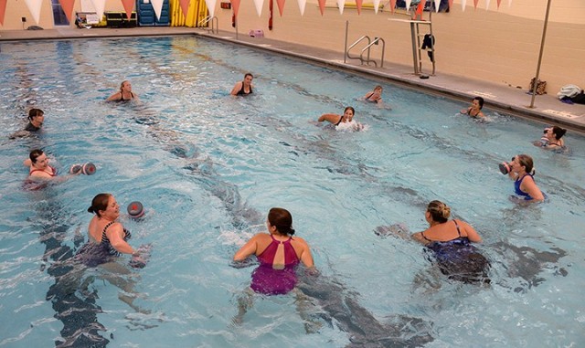 Water aerobics instructor Julie Keller leads participants during the class Aug. 14 at Harney Sports Complex. The class, the first to be offered at the post gyms since COVID-19 precautions shut down most activities, is limited to a maximum of 13 participants on a first-come, first-served basis. The class is offered at 4:30 p.m. Monday, Wednesday and Friday. Photo by Prudence Siebert/Fort Leavenworth Lamp