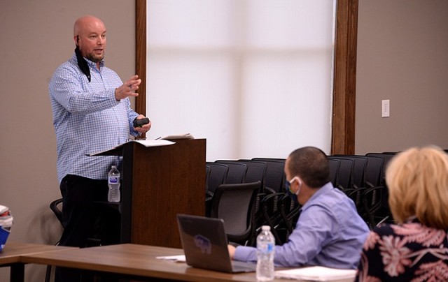 Fort Leavenworth-Unified School District 207 tabletop exercise facilitator Don Black, Fort Leavenworth Garrison emergency manager, notes the room setup, which he measured to ensure six feet of distancing, and points out that a few people have...