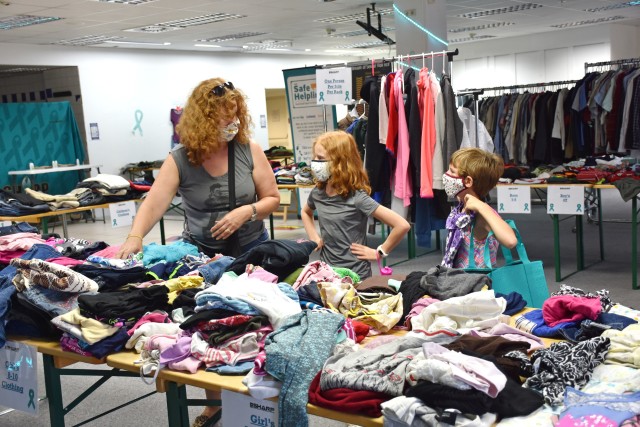 Melissa Bitter and her daughters Daisy and Evelyn (from left to right) shop clothes right before school starts at the Look SHARP Clothing Exchange Aug. 19 on Hainerberg.