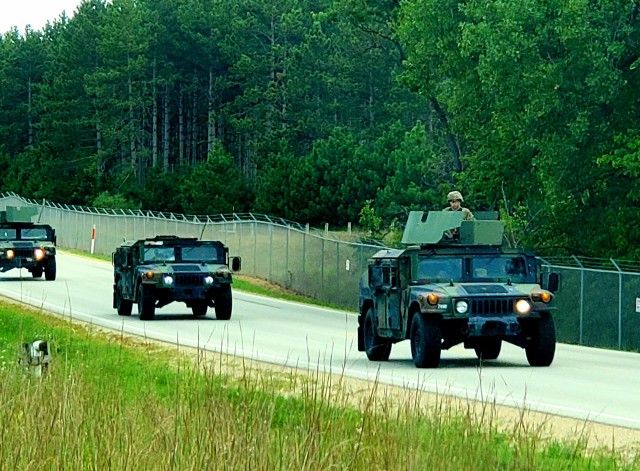 Soldiers drive military vehicles in a convoy as part of training operations Aug. 20, 2020, at Fort McCoy, Wis. During August 2020, thousands of service members were at Fort McCoy for training, including Army Reserve units and Soldiers, National Guard units and Soldiers, ROTC cadets and training staff, and more. Transient troop training like this resumed at Fort McCoy in July 2020 after being stopped for several months because of the COVID-19 pandemic response. Over months of planning, however, Fort McCoy training officials were able to reopen the training with COVID-19 safety measures built in. Fort McCoy’s motto is to be the “Total Force Training Center.” (U.S. Army Photo by Scott T. Sturkol, Public Affairs Office, Fort McCoy, Wis.)