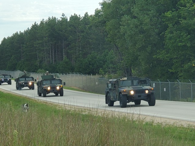 Soldiers drive military vehicles in a convoy as part of training operations Aug. 20, 2020, at Fort McCoy, Wis. During August 2020, thousands of service members were at Fort McCoy for training, including Army Reserve units and Soldiers, National Guard units and Soldiers, ROTC cadets and training staff, and more. Transient troop training like this resumed at Fort McCoy in July 2020 after being stopped for several months because of the COVID-19 pandemic response. Over months of planning, however, Fort McCoy training officials were able to reopen the training with COVID-19 safety measures built in. Fort McCoy’s motto is to be the “Total Force Training Center.” (U.S. Army Photo by Scott T. Sturkol, Public Affairs Office, Fort McCoy, Wis.)