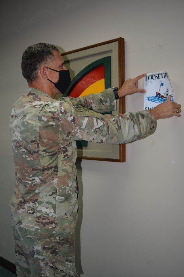 U.S. Army Soldier Master Sgt. Charles Plantamura pins an OPSEC flier on a wall in the CENTCOM area of responsibility, August 13, 2020. (U.S. Army photo by Sgt. Andrew Valenza)