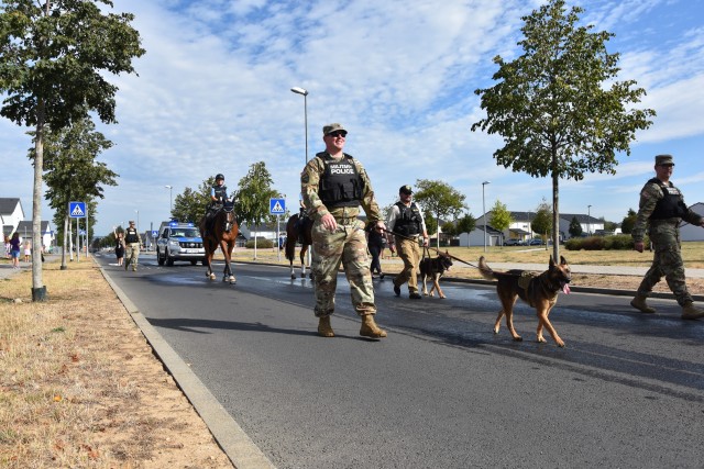 WIESBADEN, Germany - Military working dogs and their handlers walk along Via Principalis during a First Responders Day parade Aug. 21 on Clay Kaserne.