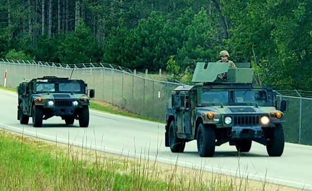 Soldiers drive military vehicles in a convoy as part of training operations Aug. 20, 2020, at Fort McCoy, Wis. During August 2020, thousands of service members were at Fort McCoy for training, including Army Reserve units and Soldiers, National Guard units and Soldiers, ROTC cadets and training staff, and more. Transient troop training like this resumed at Fort McCoy in July 2020 after being stopped for several months because of the COVID-19 pandemic response. Over months of planning, however, Fort McCoy training officials were able to reopen the training with COVID-19 safety measures built in. Fort McCoy’s motto is to be the “Total Force Training Center.” (U.S. Army Photo by Scott T. Sturkol, Public Affairs Office, Fort McCoy, Wis.)