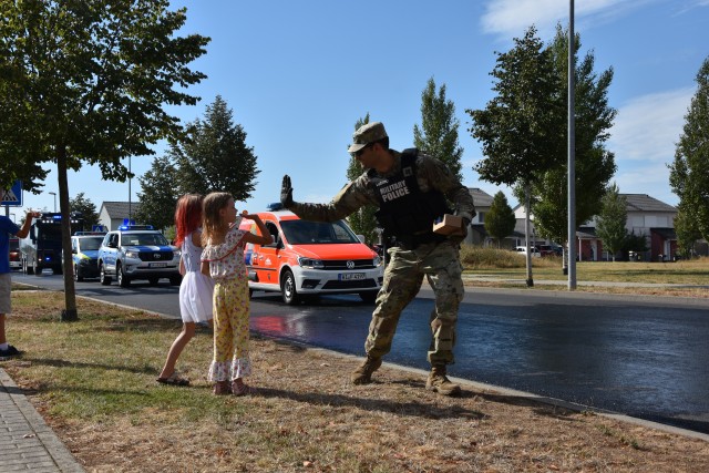 WIESBADEN, Germany – A member of the U.S. Army Garrison Wiesbaden military police gives high fives to children as he passes out candy during a First Responders Day parade Aug. 21 on Clay Kaserne.