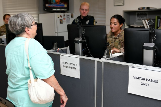 Gloria Golden, mother of the late Capt. Jonathan Golden, 39th Airlift Squadron C-130J Super Hercules pilot, gets her picture taken for her Defense Biometric Identification System ID card at Dyess Air Force Base, Texas, July 18, 2019. Golden received the ID card as a part of the Gold Star Family Member program, which allows beneficiaries base access and other privileges on any Department of Defense installation. 