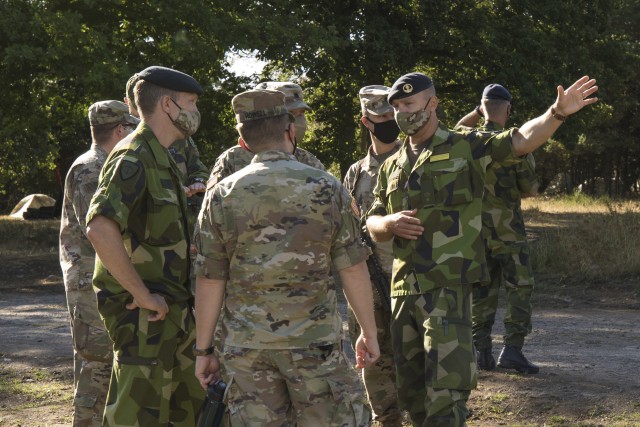 Swedish soldiers, assigned to the Air Defence Regiment, visit U.S. Soldiers assigned to the 5th Battalion, 7th Air Defense Artillery Regiment, 10th Army Air and Missile Defense Command, in Baumholder training Area, Germany on Aug. 18-20. The...