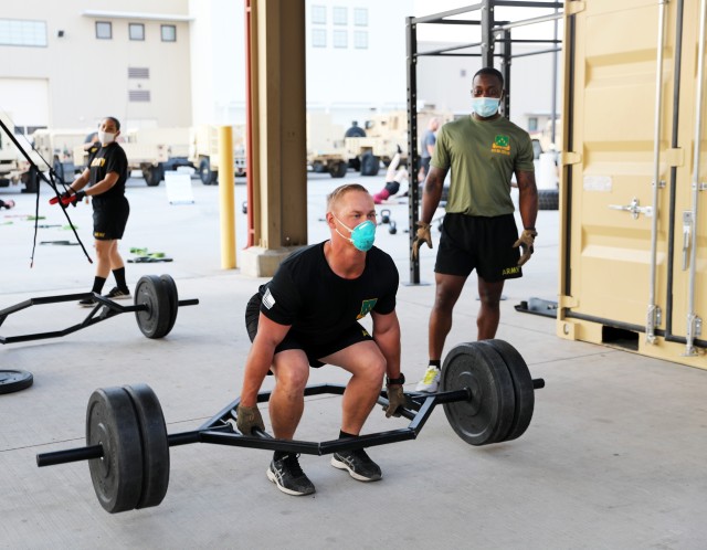 Fort Bliss, Texas – A 1st Armored Division Soldier from the 4th Battalion, 70th Armor Regiment, 1st Brigade Combat Team performs a Trap Bar Deadlift during an early morning Holistic Health and Fitness (H2F) physical training session on post, Aug. 21. As the nation slowly re-opens, Soldiers are resuming their battle rhythms while continuing to adhere to strict COVID-19 safety precautions, which can make training for combat-ready fitness and performance levels especially challenging. Despite these less structured times, it’s important for Soldiers to stay in top form in order to maximize performance output and carry out missions effectively. (U.S. Army photo by Jean S. Han)