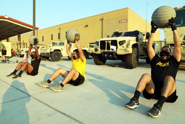 Fort Bliss, Texas – 1st Armored Division Soldiers from the 4th Battalion, 70th Armor Regiment, 1st Brigade Combat Team perform Medicine Ball Situps during an early morning Holistic Health and Fitness (H2F) physical training session on post, Aug. 21. As the nation slowly re-opens, Soldiers are resuming their battle rhythms while continuing to adhere to strict COVID-19 safety precautions, which can make training for combat-ready fitness and performance levels especially challenging. Despite these less structured times, it’s important for Soldiers to stay in top form in order to maximize performance output and carry out missions effectively. (U.S. Army photo by Jean S. Han)
