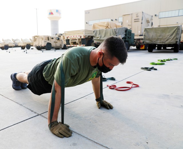 Fort Bliss, Texas – A 1st Armored Division Soldier from the 4th Battalion, 70th Armor Regiment, 1st Brigade Combat Team performs a Resistance Band Pushup during an early morning Holistic Health and Fitness (H2F) physical training session on...