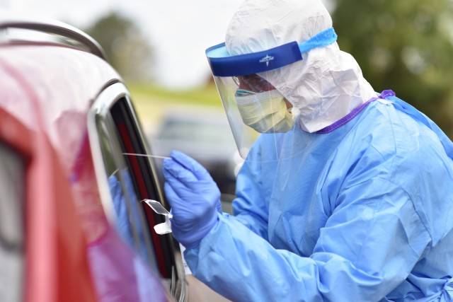 Cpl. Samuel Ross performs a COVID-19 nasal swab at a drive-thru testing site in Cheatham County, April 3. Ross, assigned to Tennessee National Guard's Medical Detachment, was activated after Gov. Bill Lee requested 250 Soldiers and Airmen from the...