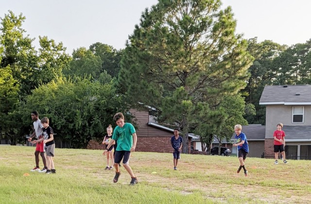 Neighborhood kids from Fort Polk's Dogwood terrace run various speed and conditioning drills under the directio nand supervision of Staff Sgt. (Coach) Johnathan Arnold, 2nd Battalion, 30th Infantry Regiment, 3rd Brigade Combat Team, 10th Mountain...
