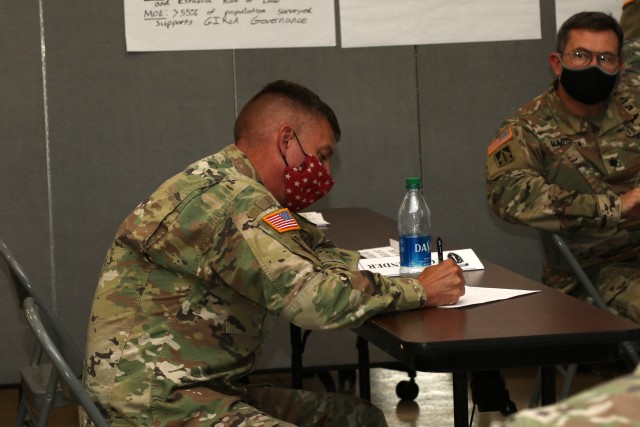 Col. Jeff Hackett, Commander, 54th Security Forces Assistance Brigade, takes after action review notes during the Command Post Exercise training event at Camp Atterbury, IN, August 12, 2020.  (U.S. Army photo by Sgt. James Hobbs)