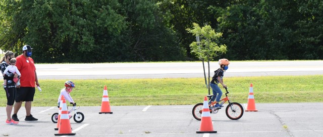 Fort Drum children practiced bicycle safety while having fun Aug. 26 during a Bike Rodeo at the Magrath Sports Complex parking lot. The event was hosted by Fort Drum Family and Morale, Welfare and Recreation, with the American Red Cross as event sponsor. (Photo by Mike Strasser, Fort Drum Garrison Public Affairs)