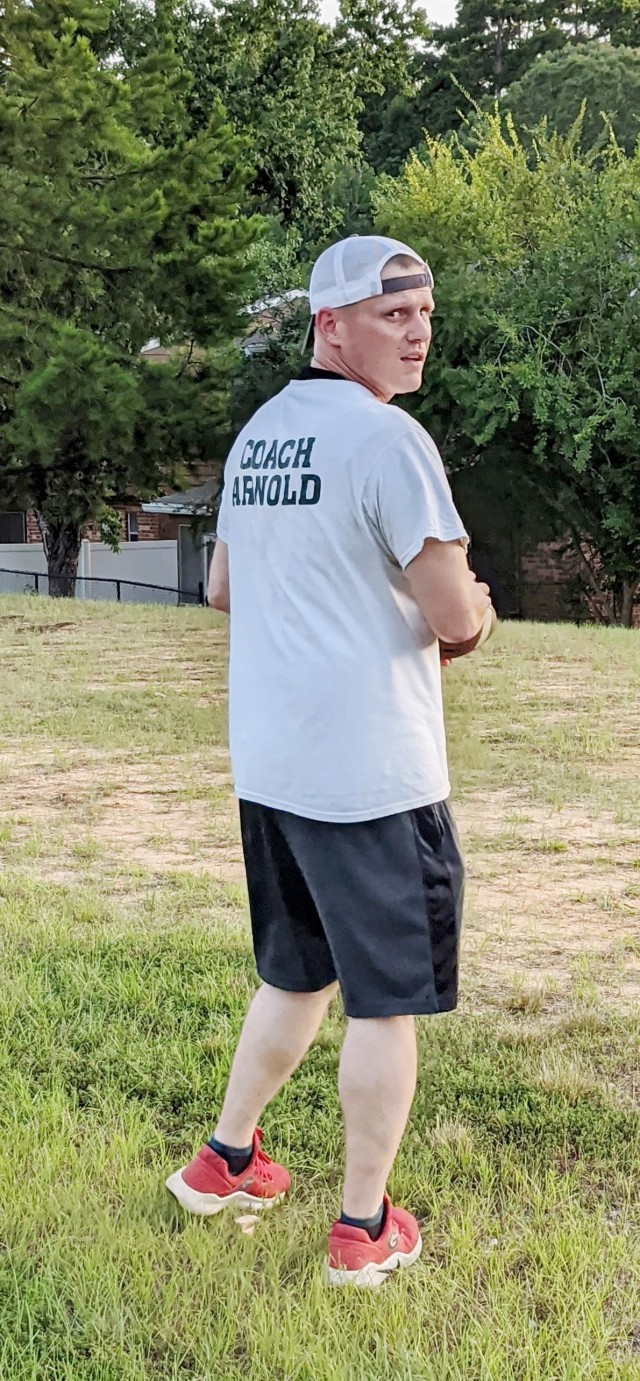 Responding to the lack of kids’ activities due to the pandemic, football coach and noncommissioned officer, Staff Sgt. Jonathan Arnold, holds football practice on Aug. 10 in an open, grassy field in the Dogwood Community Terrace community of...