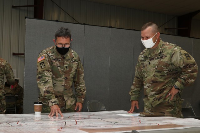 Lt. Col. Greg Marcuson, Deputy Commander, 54th Security Forces Assistance Brigade, and Lt. Col. Jason Staraitis, Commander, 2nd Battalion, 29th Infantry Regiment, review the area of operations for the Command Post Exercise training event at Camp Atterbury, IN, August 12, 2020.  (U.S. Army photo by Sgt. James Hobbs)