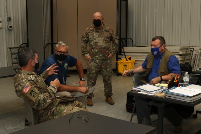 OC/Ts assigned to 157th IN BDE and training support personnel discuss the Command Post Exercise training scenario at Camp Atterbury, IN, August 12, 2020. (U.S. Army photo by Sgt. James Hobbs)