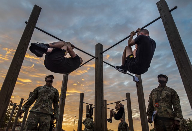 The top command sergeants major from across the U.S. Army Reserve perform the leg tuck for a practice ACFT at Fort Eustis, Va., Oct. 25, 2019, during the Army Reserve Senior Enlisted Council.