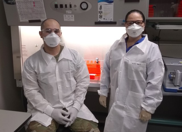Spc. Darius Torres, a medical laboratory technician, and Milagros Solá, a microbiologist, both from Public Health Command-Pacific at the Environmental Molecular Biology Laboratory at Joint Base Lewis-McChord, Wash. Normally, PHC-P EMBL personnel focus on vector borne diseases found in ticks, mosquitos, and fleas by testing arthropod samples found in austere environments, however, since the start of the COVID-19 pandemic PHC-P personnel have been helping clinical laboratories process COVID-19 samples. (Courtesy photo)