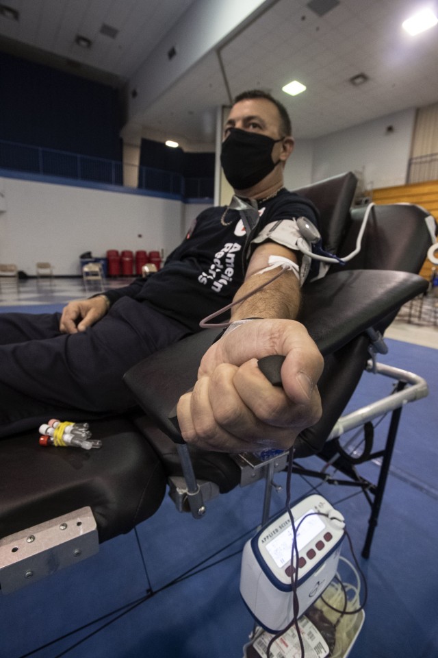 William Sexton, Fort Jackson fire inspector, squeezes his fist while donating blood. ‘It’s a very minor needle prick,’ he said. ‘That blood you give is life. You can certainly save lives by donating.’