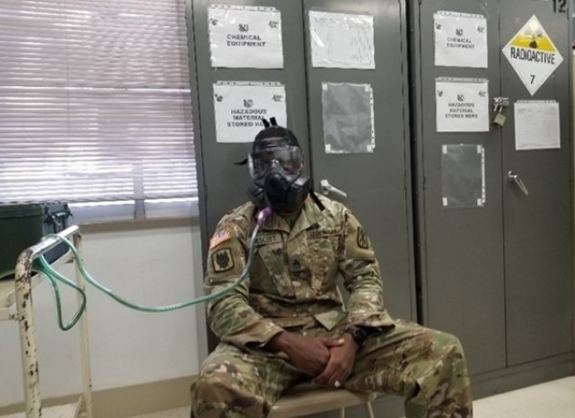 Staff Sgt. Felix Prescott uses the Protective Assessment Test System to ensure his field protective mask functions properly, in December of 2019.