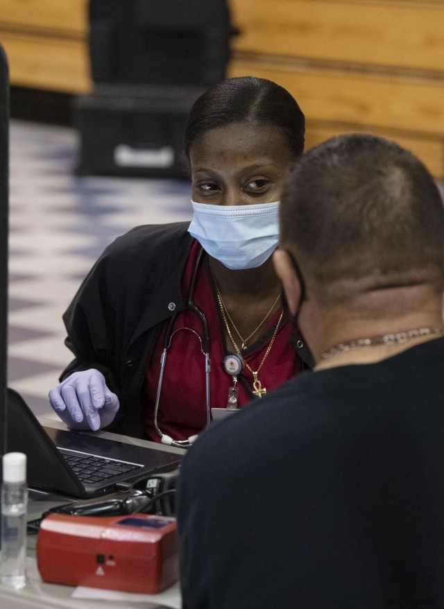 Shawna Porterfield, a collections specialist with the American Red Cross, asks William Sexton, Fort Jackson fire inspector, before allowing him to donate blood at the Community Blood Drive Aug. 25 in the Solomon Center.