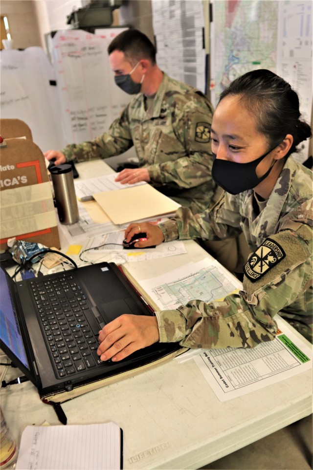 Maj. Dan Bartlett and Capt. Hyeon Kim, both who served as operations officers with ROTC training at Fort McCoy in early August 2020, plan some training Aug. 13, 2020, in a building at the Combined Arms Collective Training Facility on South Post at...