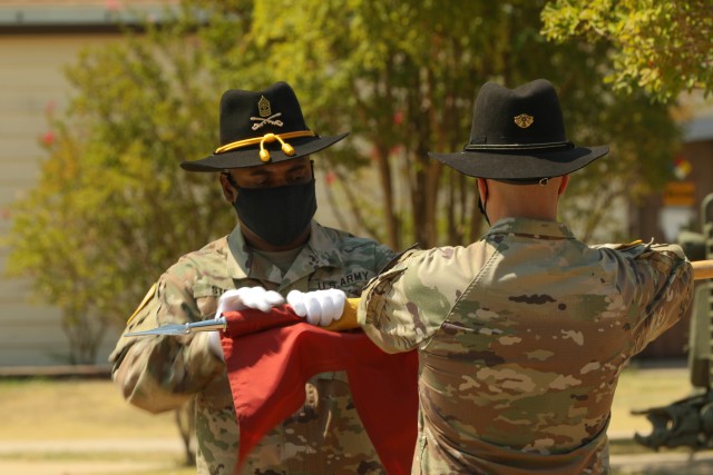 The 154th Composite Truck Company Commander, Capt. Anthony Alteri and company First Sergeant, 1st Sgt. Antwain Stokes, case the unit’s guidon during a ceremony at the 1st Cavalry Division museum on Fort Hood, Texas, August 18, 2020. The company...