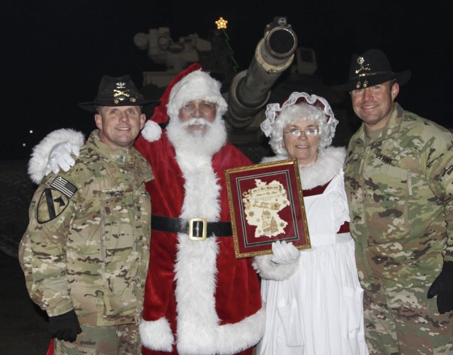 Col. Jeremy Wilson, commander of the 2nd Armored Brigade Combat Team, 1st Cavalry Division, and Lt. Col. Jonathan Bender, commander of 1st Battalion, 8th. Cavalry Regiment, 2ABCT poses with Santa during the 5th Annual Tree Lighting Ceremony at...