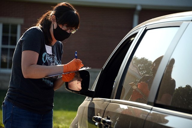 Crystal Lewis, prayer coordinator for Protestant Women of the Chapel, registers Tamerra Rodriguez for PWOC so she can receive Zoom links to upcoming meetings during the PWOC drive-in fall kickoff Aug. 25. PWOC members listened to the kick-off...