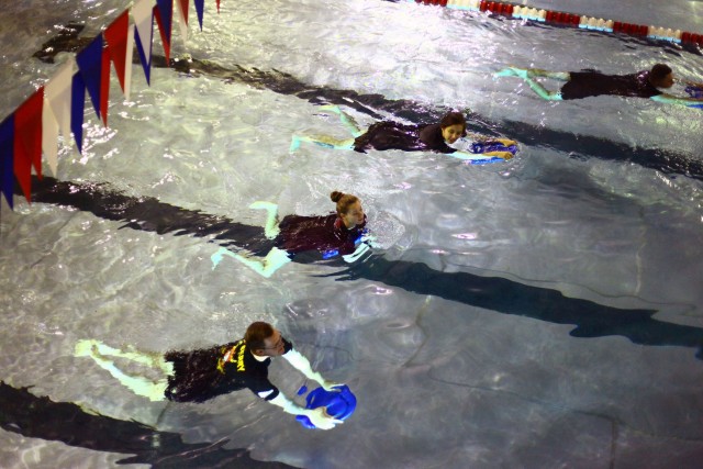 P3T Soldiers along with their instructors use swimming boards as they strengthen their legs and improve their kicking  Aug. 21, at the Rinehart Fitness Center pool. The instructors use a variety of methods to help Soldiers regain strength and flexibility, and improve their cardiovascular system by using pool weights and swimming laps.