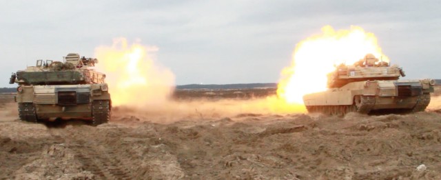 M1A2 Abrams tanks from Bravo Company, 1st Battalion, 9th Cavalry Regiment, 2nd Armored Brigade Combat Team, 1st Cavalry Division, fire at targets during the Norwegian Company Combined Arms Live Fire Exercise on the range in Pabrade, Lithuania...