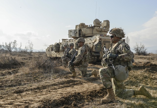 Soldiers with C Company, 1st Battalion, 5th Cavalry Regiment, 2nd Armored Brigade Combat Team, 1st Cavalry Division, pull security while training to clear an open engagement area during a dry rehearsal for a Combined Arms Live Fire Exercise...